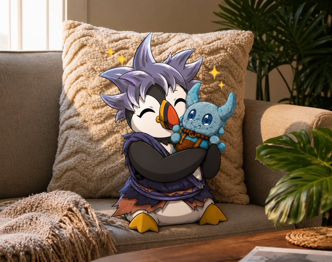 The image features a cartoon penguin sitting on top of a couch, holding a blue stuffed animal plushie. The penguin has a unique appearance with its hair styled like a bird's head and a blue body. The background shows a beige pillow and a plant in the room. There is also text that reads "I was lucky enough to secure an @OthersideMeta Koda plushie on @phygitals before they sold out Can't wait to have this little piece of Web3 in my living room". This post seems to be related to the image, as it features a cute cartoon penguin holding a stuffed animal.