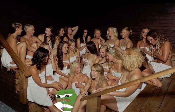 A group of women wrapped in white towels gathered together in what appears to be a sauna, with a Pepe the Frog meme superimposed at the bottom.