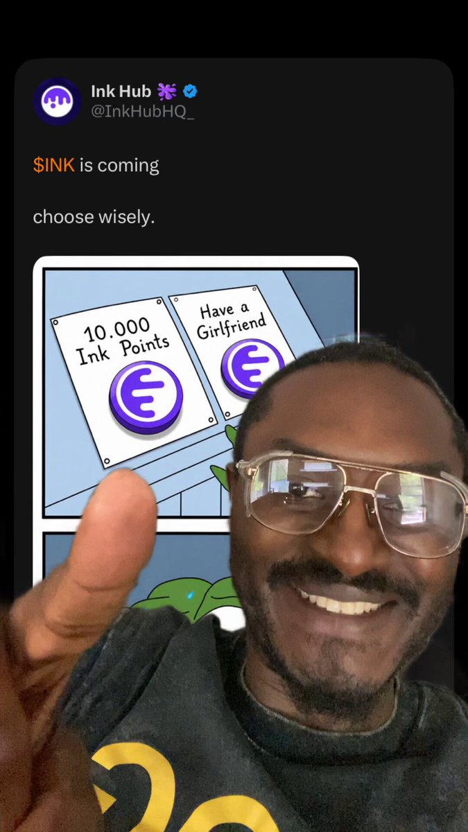 The image shows a man wearing glasses, smiling at the camera while giving a thumbs up gesture. He is dressed casually in a black shirt with a yellow logo. The background of the image features two signs that say "SINK IS COMING" and "10,000 GIRLFRIEND". These signs are placed above a picture of a green plant on which there is an arrow pointing to it.