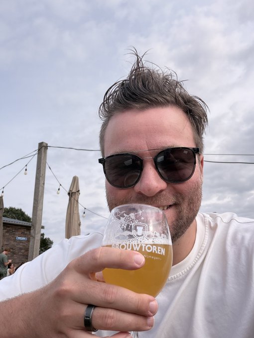 A man wearing sunglasses smiles while sipping from a "Brouwtoren" beer glass against a cloudy sky, celebrating his crypto gains with a cold brew. The relaxed, victorious vibe of the photo mirrors the post's triumphant mood about $PONS hitting a 13X return.