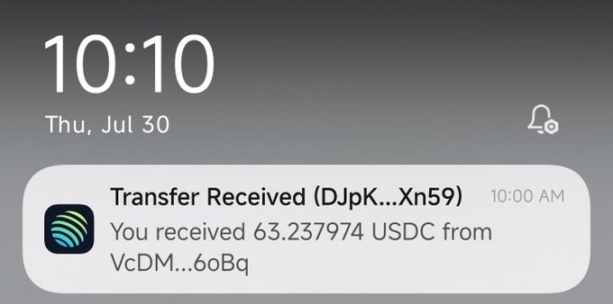Phone lock screen showing time 10:10 AM on Thursday, July 30, displaying a notification: 'Transfer Received - You received 63.237974 USDC from VcDM...6oBq'.