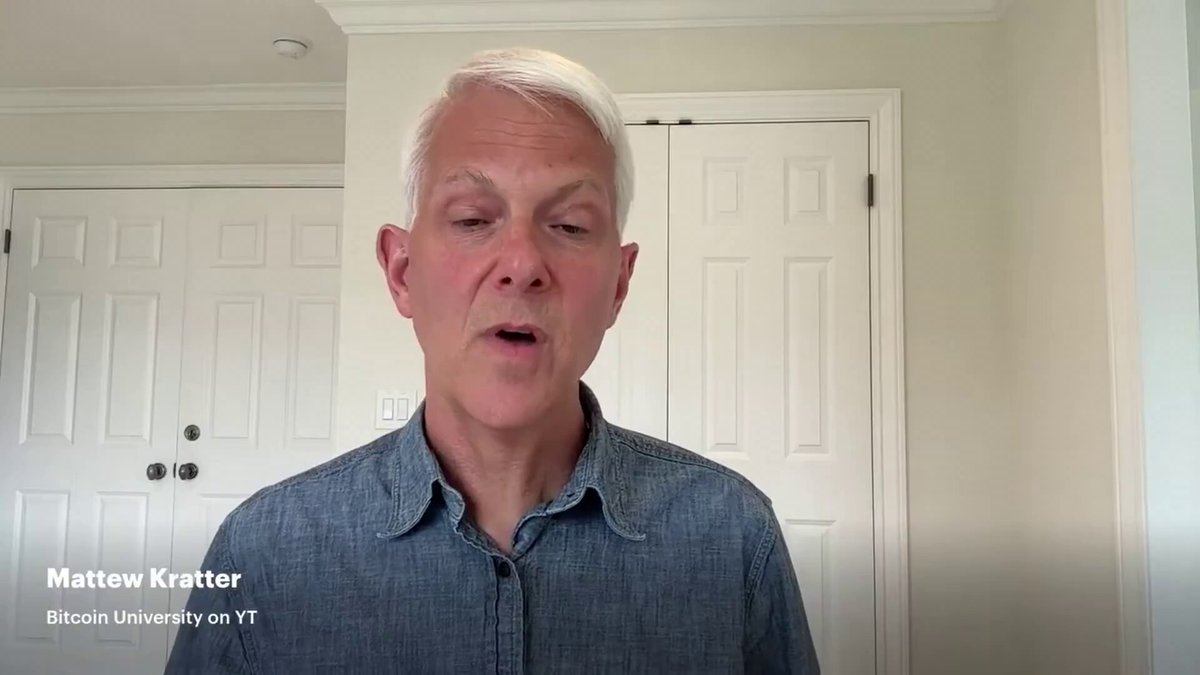 In this image, there is a man wearing a blue shirt standing against a white wall with two doors behind him. The man appears to be talking or giving a speech, as indicated by his facial expression. The caption of the image reads "Matthew Kratter from Bitcoin University on the importance of Bitcoin in self custody: All of us grew up in a very fiat world and we grown up thinking in very fiat ways... so we'r quite used to abdicating our responsibility for our money." This message seems to be related to the discussion about Bitcoin's role in self-custody.
