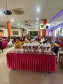 The image shows an indoor gathering with a long table covered in a pink tablecloth, set up in what appears to be a banquet hall or restaurant, with people standing in the background.

The post doesn't relate to this image at all. The image depicts a banquet/event setup, while the post discusses Pi Network's V26 protocol upgrade scheduled for August 11, 2026. There is no visible connection between the physical gathering shown and the cryptocurrency network mentioned in the text.
