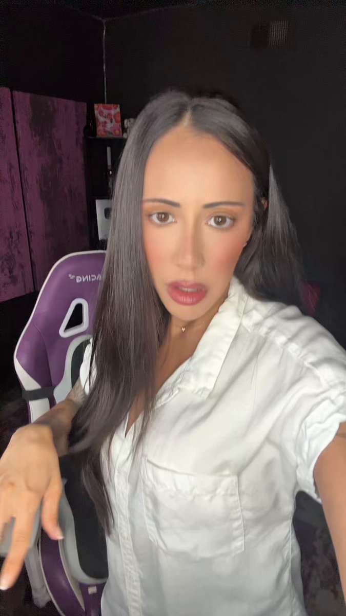 The image shows a woman wearing a white shirt, with long brown hair, posing for a photo. She has her hand outstretched towards the camera, making a peace sign gesture. The caption of the image reads "Focus on what is in the image and how it relates to the post". This suggests that there might be some connection between the Senate housing bill and the CBDC ban or at least an attempt to draw attention to them through the photo.