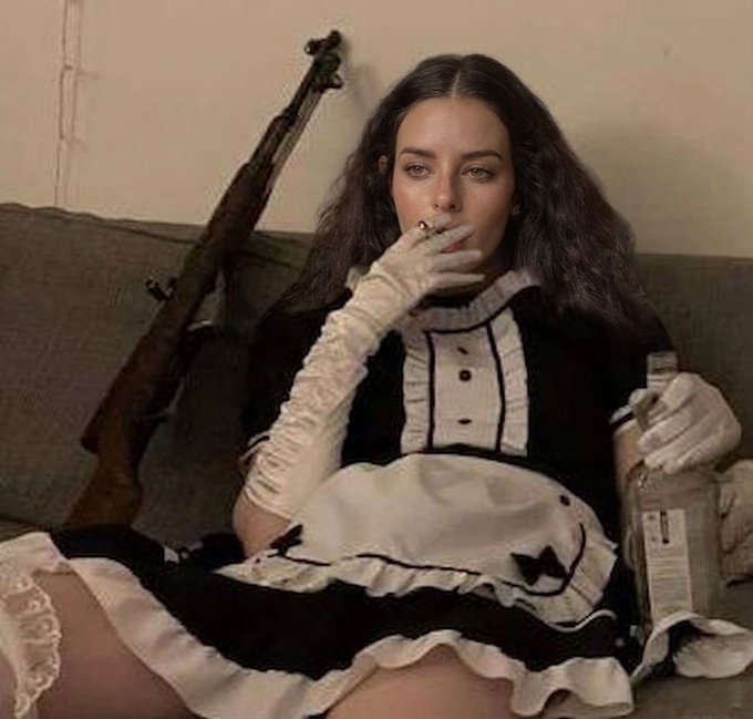 A woman in a black-and-white maid outfit reclines on a couch in vintage style, smoking a cigarette while holding a bottle, with a rifle resting behind her. The image's darkly humorous juxtaposition of glamorous exhaustion with the absurdity of the post's complaint about crypto market-induced lifestyle contradictions perfectly captures the "bear market blues" mood.
