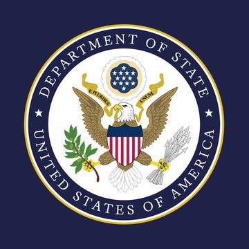 The image shows the official seal of the United States Department of State, featuring an eagle holding an olive branch and arrows with a shield, encircled by the text "DEPARTMENT OF STATE" and "UNITED STATES OF AMERICA." The seal is relevant to the accompanying post because the U.S. Department of State, through the U.S. Embassy in Russia, issued the urgent advisory urging American citizens to leave the country immediately.