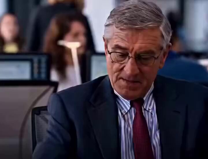 The image shows an older man wearing glasses, sitting at his desk with a computer screen in front of him. He appears to be looking down or thinking deeply about something. The caption above the image reads "Bringing RWA onchain is great, AAPL onchain ... NVDA onchain ... treasuries onchain ... gold onchain but can a normal fintech user actually buy it in one click?". This suggests that the man might be discussing financial matters or analyzing market trends related to RWA (Royal Wages Allowance) and how they impact the stock market.