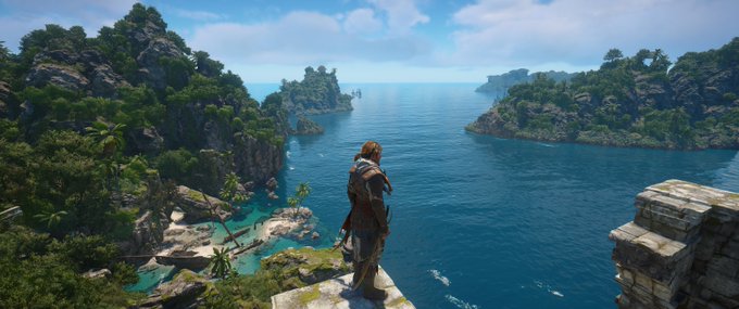A vibrant in-game screenshot of a character standing on a stone ledge, gazing out over a tropical seascape with lush green islands, cliffs, and turquoise water under a bright blue sky.