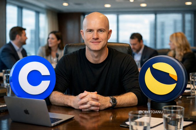 A bald man sits at a conference table flanked by large Coinbase (blue 'C') and LUNA (yellow/blue) logos, with a watermark reading '@CRYPTOANU' visible.
