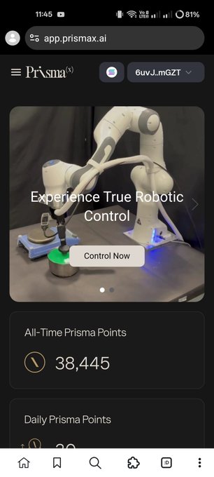 The image shows a phone screen displaying an app called "PrismaX" with a website link at the bottom of the screen. The app appears to be related to robotics or automation technology, as indicated by its name. The user interface features a menu bar with various options and buttons for navigation. There is also text on the screen that reads: "If you are still sleeping on PrismaX, this is your official wake-up call. I’ve been personally tracking every single update, and the ecosystem is expanding way faster than anyone expected. It's safe, fast, and genuinely built for the future." The image does not provide any specific information about the app or its features but rather focuses on the overall appearance of the phone screen and the content displayed in the app.