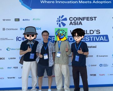 Four people pose together at the 'COINFEST ASIA' 'WORLD'S [CRYPTO] FESTIVAL' with the tagline 'Where Innovation Meets Adoption' visible in the background.