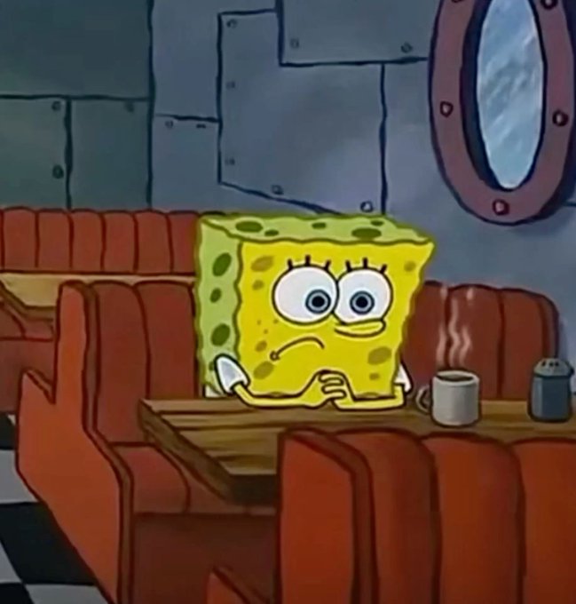 SpongeBob SquarePants sits alone at a booth in a diner, looking nervous with his hands clasped on the table next to a steaming mug of coffee.