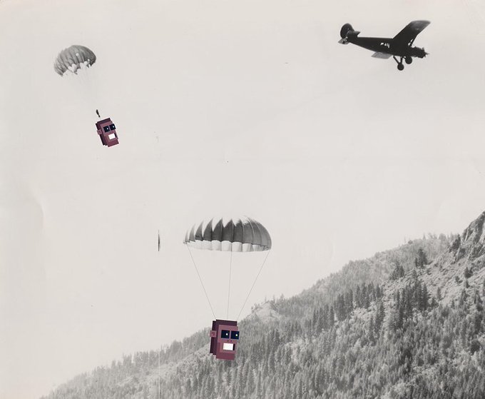 A surreal black-and-white scene shows a small airplane flying in the sky above a forested mountain, while pixelated red mailbox-like structures descend via parachutes.