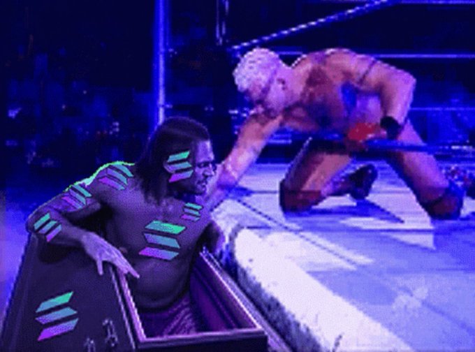 The image shows a man kneeling down next to a box with a purple lid that has "@SOLANA DEX" written on it, which appears to be a return address for wrestling equipment. The box contains over 20,000 wrestling belts that have been returned by customers and are now being distributed back into circulation.