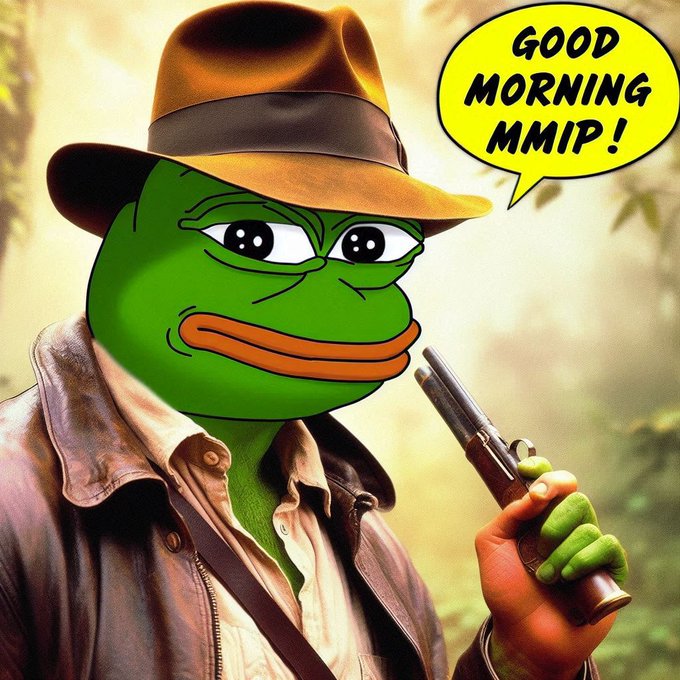The image is a meme featuring the green Pepe frog character dressed as an adventurer in a brown fedora hat and leather jacket, holding a revolver, with a speech bubble that says "GOOD MORNING MMIP!" The caption playfully relates to the post by combining the iconic Pepe meme with the $MMIP (Memes Make It Possible) token, embodying the spirit of crypto memetics and community-driven humor.