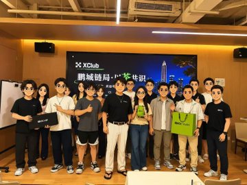 A group photo of approximately twelve people posing together in front of a screen displaying 'XClub' and Chinese text, with several individuals holding shopping bags.