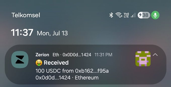An iPhone lock screen notification from Zerion shows 100 USDC received on the Ethereum network from address 0xb162...f95a, on Telkomsel network at 11:37 on Mon, Jul 13.