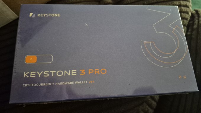 A photograph of a sealed retail box for a 'Keystone 3 Pro Cryptocurrency Hardware Wallet' with an orange QR-style logo.