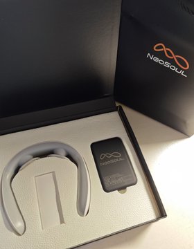 An open product box shows a black neckband-style wearable device and its charging accessory, with the 'Neosoul' brand name visible on the packaging.