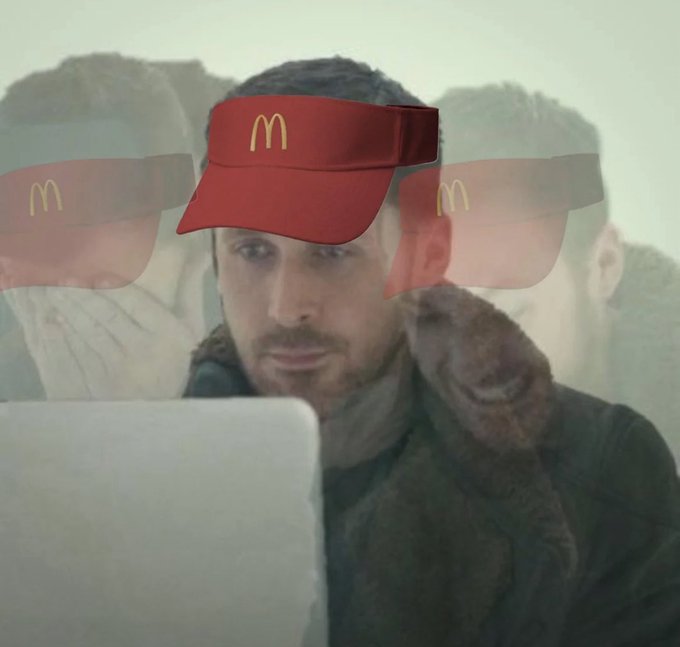 A man with a beard appears focused on a laptop screen, his face digitally edited to wear a red McDonald's visor with the golden "M" logo, while ghostly reflections of himself loom in the background. The surreal imagery humorously visualizes the post's idea of someone barely holding onto their fast-food-job composure as the market crashes around them.