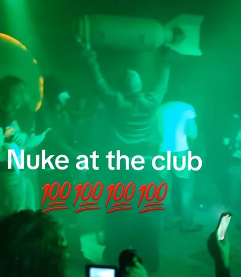 A meme image overlaid on a green-tinted club scene showing a person holding what appears to be a bomb or weapon, with text reading 'Nuke at the club' and '100 100 100 100' in red.
