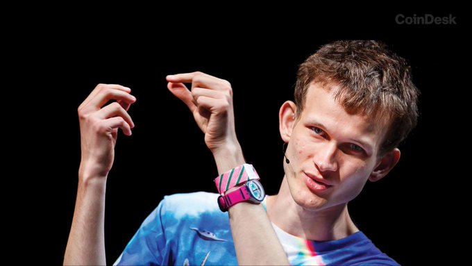 Vitalik Buterin, Ethereum's co-founder, is pictured on stage wearing a colorful blue and pink shirt and a pink wristwatch, likely during a conference presentation. The image accompanies his warning about AI potentially accelerating cryptographic attacks on lattice-based systems, while advising against rushing wallet migrations due to his personal losses from failed migrations exceeding those from hacks.