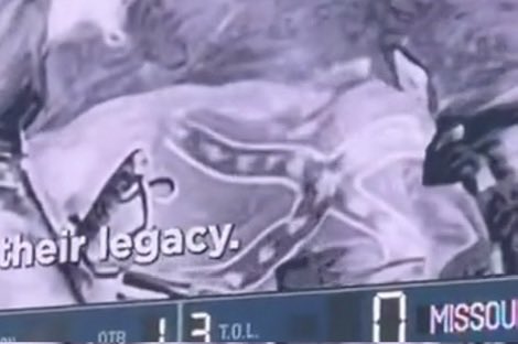 A blurry screen capture showing partial text 'their legacy.' over an indistinct image, with a sports ticker at the bottom displaying 'OTB 13 T.O.L. 0 MISSOU'.