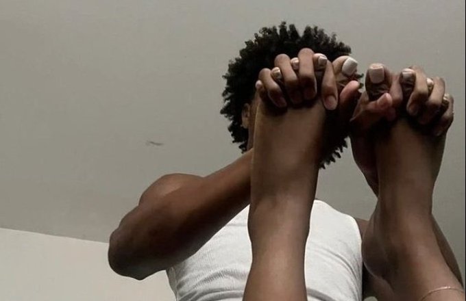 A person with curly hair sits with their feet raised in front of their face, hands gripping their toes in a pose that humorously suggests defeat or resignation. The image complements the post's caption about struggling to earn money in web3, visually representing the "no clue" or "overwhelmed" reaction to the question.