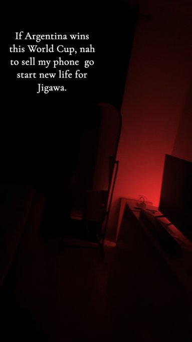 Dark, red-lit room photo with overlaid text reading: "If Argentina wins this World Cup, nah to sell my phone go start new life for Jigawa."