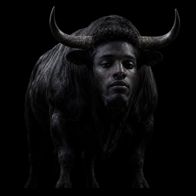 A surreal, dark-toned digital artwork depicts a powerful black bull with a human face seamlessly merged into its head, symbolizing strength, identity, and artistic ownership. The caption "Absolute Cinema! OG still means OG no matter what. This is our art, our concept and our hardwork! They can't kill us!" reflects the image's bold, defiant message of original creative ownership and unbreakable artistic spirit.