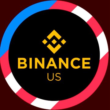 The Binance.US logo featuring the yellow Binance diamond symbol and 'BINANCE US' text within a circle bordered by blue, white, and pink stripes on a dark red background.