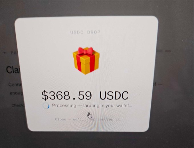 A screenshot showing a USDC DROP of $368.59 USDC processing, with a gift box icon and text indicating it is 'landing in your wallet.'