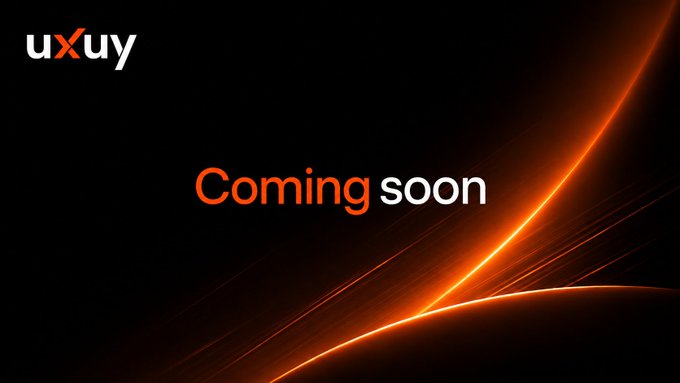 The image features a sleek black background with glowing orange curved light streaks and the text "Coming soon" alongside the "uxuy" logo. It serves as a teaser announcement, with the bold "Coming soon" message building anticipation and connecting to the post's hint that something new is on the horizon.