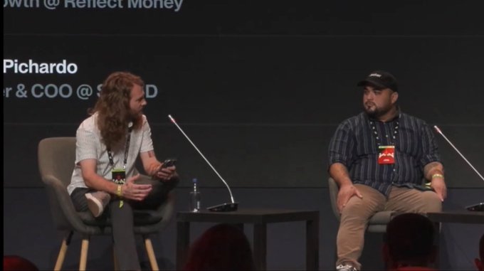 A panel discussion with two seated speakers at what appears to be a conference, with one person labeled 'Pichardo' identified as Founder & COO, with another speaker listed as @Reflect Money.