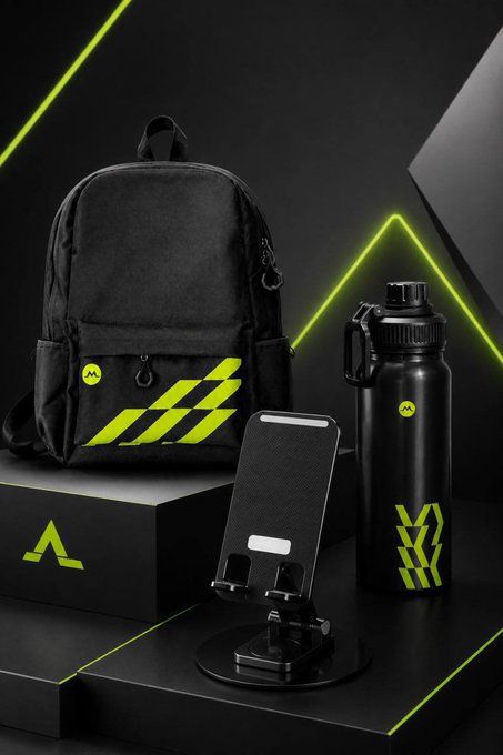 Black backpack, water bottle, and phone stand with neon green accents branded with an 'M' logo on a dark display.
