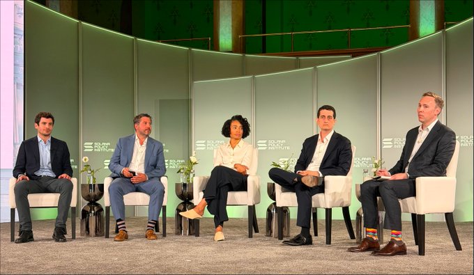 The image shows a group of five people sitting in chairs around a table at an event. They are all dressed professionally, with one person wearing a suit and tie, another in a suit and white shirt, and three others in suits and ties. The setting appears to be a conference room or a similar indoor space designed for presentations or discussions.

The image also contains text that reads "How does the CLARITY Act affect institutional players in digital assets? At the @SolanaInstitute's Washington x Wall Street event, Grayscale Chief Legal Officer @CraigSalm joined legal and policy minds from Gibson Dunn, WilmerHale, @jump_, and @solanainstitute to unpack the". This suggests that the image is related to a panel discussion or a meeting where legal experts are discussing the impact of the CLARITY Act on digital assets.