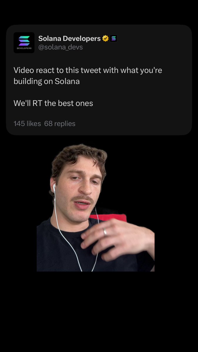 The image features a man wearing headphones, with his hand resting on his hip or shoulder. He appears to be looking at something off-camera while holding a red object. The background of the image is black, which contrasts with the white text that reads "Video react to this tweet with what you're building on Solana". This suggests that the man might have been watching a video related to the development or launch of a project involving Solana, and he's reacting to it by holding up the red object.