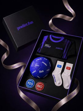 A black and purple product box labeled 'predict.fun' containing a folded jersey, a small soccer ball, two socks (one blue 'YES' and one red 'NO'), and buttons with 'YES' and 'NO', surrounded by a curling ribbon.
