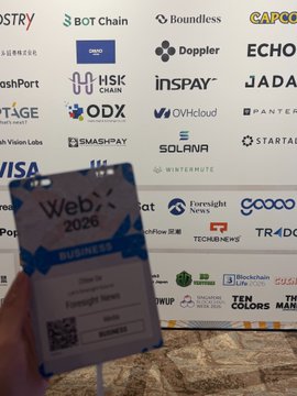 A hand holding a 'Web3 2026 Business' VIP pass in front of a step-and-repeat sponsor banner featuring logos like BOT Chain, Boundless, Dopplr, ECHO, and Visa.