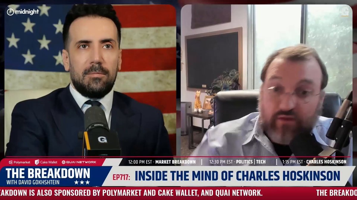 The image shows a man wearing a suit, sitting at a desk with an American flag behind him. The man appears to be talking into a microphone or a TV camera while another person can be seen in the background. The caption of the image reads "Inside the Mind of Charles Hoskinson" and there is text that says "ADA & NIGHT are worth the hype".