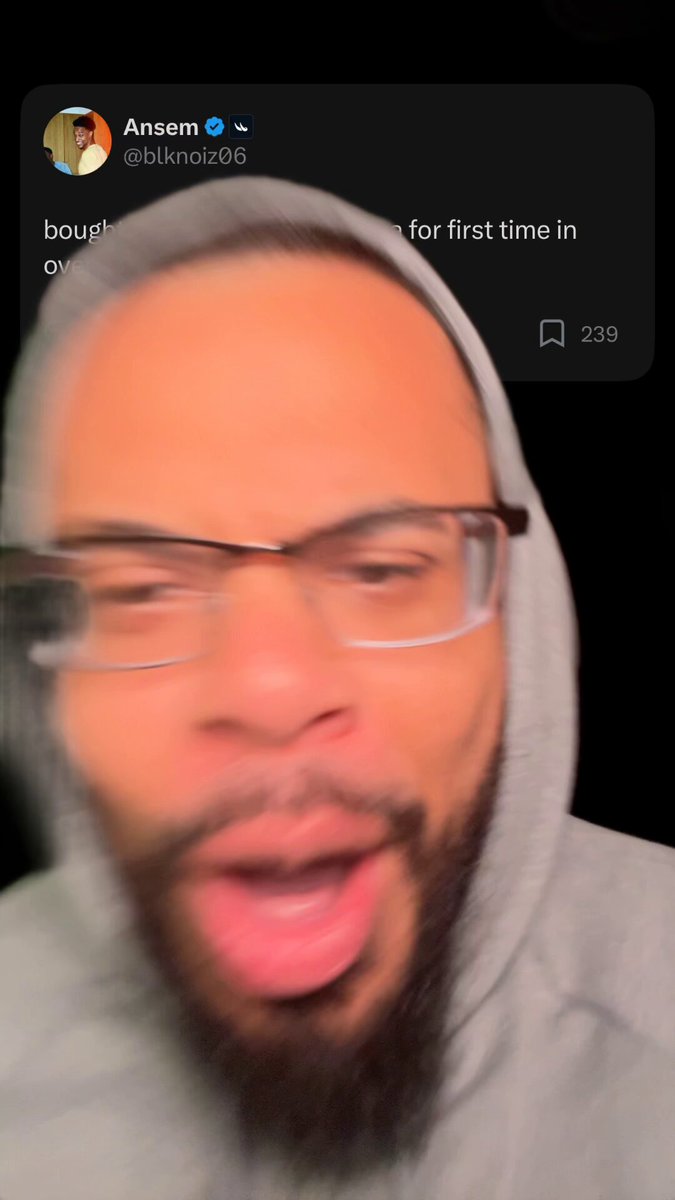 The image features a man wearing glasses, with his face blurred out against a black background. The caption of the image reads "Ansem returns to Memecoins. Welcome home nigga. @blknoiz06 Now buy some $TROLL and bull post for us." This message is related to the post on social media where Ansem has returned, and he is encouraging people to buy some stock in his account. The blurred image of the man's face adds a sense of anonymity or intrigue to the post.