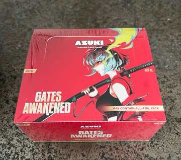 An Azuki TCG "Gates Awakened" trading card booster box (all-foil pack) is displayed, featuring anime artwork of a swordsman on red packaging. The image complements the post's reference to @AzukiTCG by showcasing official merchandise from the trading card game, coinciding with reports of a 16% rise in Azuki OG floor prices since the TCG's launch.