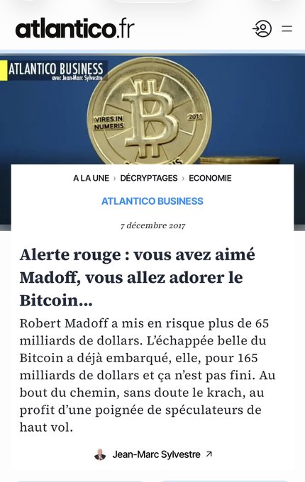 An article from atlantico.fr titled "Alerte rouge : vous avez aimé Madoff, vous allez adorer le Bitcoin..." dated December 7, 2017, by Jean-Marc Sylvestre, features a gold Bitcoin token on a blue background and warns that Bitcoin's $165 billion rally could end in a crash benefiting high-rolling speculators, echoing the post's "RIP JM Sylvestre" tribute by highlighting his famous early skeptical prediction about Bitcoin.