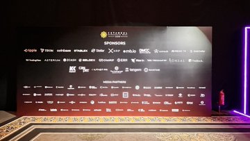 The image shows a large black wall with white text that reads "Sponsors". The text is arranged in rows of different sizes, creating a visually appealing layout. The wall also features logos for various companies such as "Beldex", "Istanbul Block Wk Connecting", and "@IstanbulBlockWk Connecting". These logos are placed at the bottom of the image, indicating that they are part of an event or gathering related to the concept of "Sponsors" in Istanbul. The text is written in a clear and legible font, making it easy for attendees to read and understand the information displayed on the wall.
