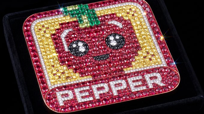 A glittering jeweled pendant depicts a smiling cartoon toast slice with a green leaf on top, framed by pink and yellow gems, with "PEPPER" spelled out in diamonds at the bottom.