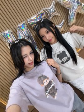 Two young women posing for a selfie together wearing matching graphic t-shirts with cartoon bear designs.