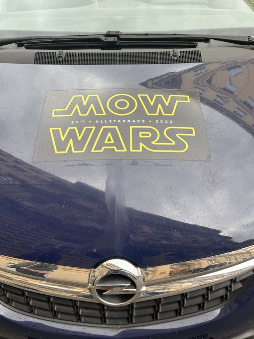 The image features a car with a sticker that reads "Mow Wars". The car has a silver grill, black bumper, and a logo on the hood. There's also a Bitcoin company name written below the Mow Wars sticker. The text in the image seems unrelated to the Bitcoin companies or VC-financed fiat companies wrapped in Bitcoin. It appears to be a random assortment of words that do not seem to have any connection to the Bitcoin theme.

The post includes a reference to Bitcoin and mentions "Mow Wars". However, it does not provide any specific information about Bitcoin companies or VC-financed fiat companies wrapped in Bitcoin. The focus of the image seems to be on the car with the Mow Wars sticker rather than discussing Bitcoin or financial matters.