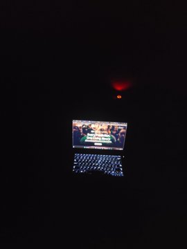 The image shows a laptop screen displaying an advertisement for a product, with a red light above it. The background of the image is dark, which contrasts with the bright screen of the laptop. The text "Day 1 building and shipping my product on @WalrusProtocol More Updates coming thoon!!".