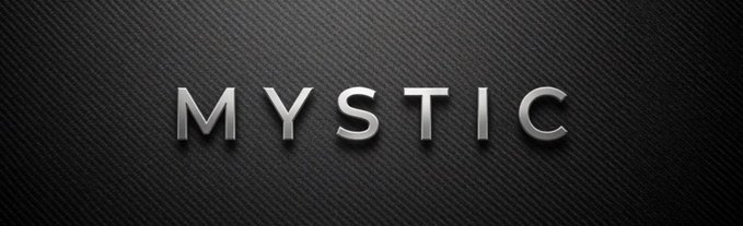 A sleek, dark graphic featuring the word 'MYSTIC' in metallic silver capital letters against a textured black carbon-fiber-style background.