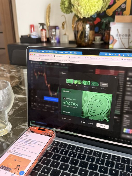 A laptop displays a trading chart showing a +92.74% gain on a SPON position, with a smartphone showing Discord messages placed next to it on a marble surface.
